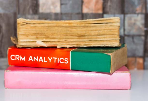 istock Crm Analytics- Business Book Title on wooden white table 1061668962