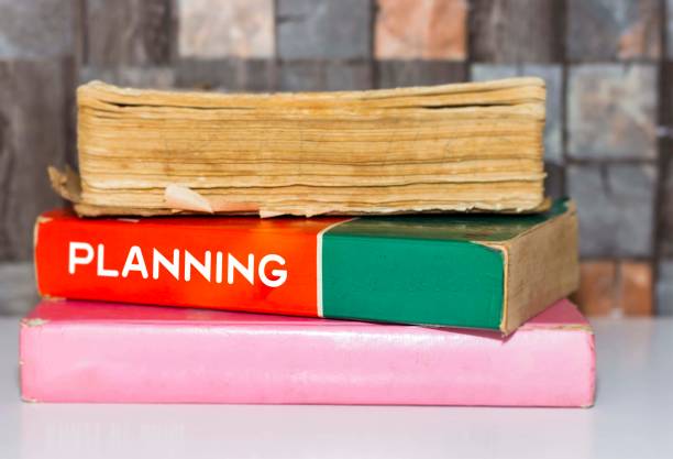 istock Planning - Business Book Title on wooden white table 1061669392