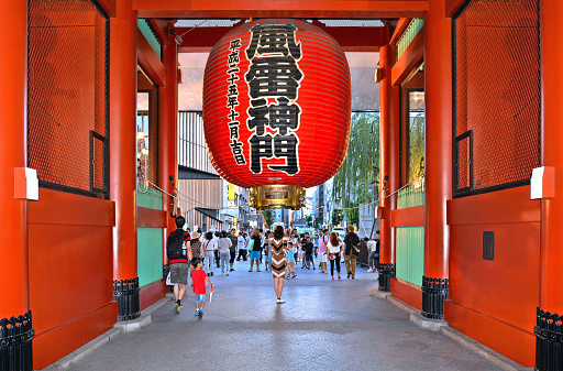 29.08.2017. Young woman taking photo with giant red lantern at Kaminarimon gate, entrance of Sensoji temple, at Asakusa, Tokyo, Japan