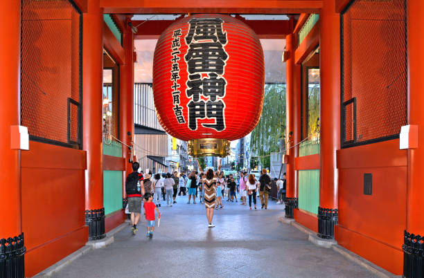 Young woman taking photo with giant red lantern at Kaminarimon gate, entrance of Sensoji temple, at Asakusa, Tokyo, Japan 29.08.2017. Young woman taking photo with giant red lantern at Kaminarimon gate, entrance of Sensoji temple, at Asakusa, Tokyo, Japan sensoji stock pictures, royalty-free photos & images