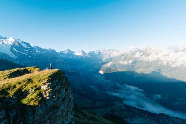 istock Hiker stands on mountain meadow crest 1061673492