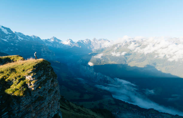 istock Hiker stands on mountain meadow crest 1061673512
