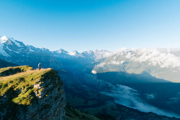 istock Hiker stands on mountain meadow crest 1061673586