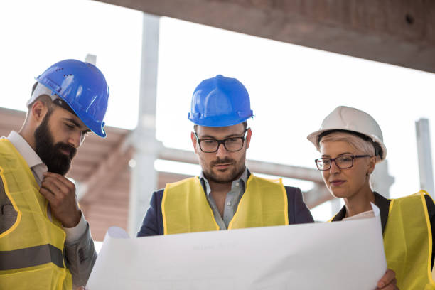 istock A team of three architects is at a construction site. 1061676742
