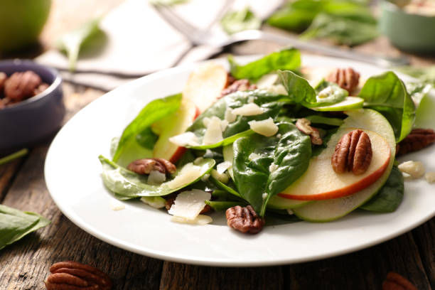 istock spinach salad with apple and pecan 1061676954