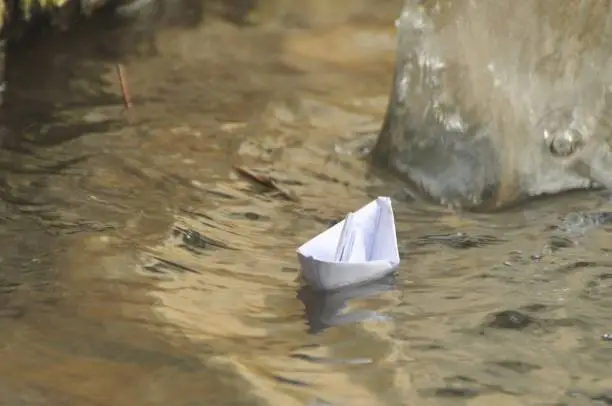 Paper boat in water