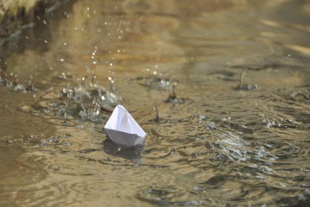 istock Paper boat in water 1061677104