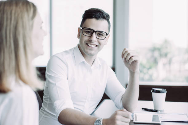 istock Successful young executive sitting at table with female colleague 1061677308