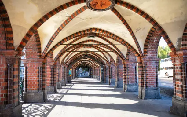 Arches and columns on Oberbaum bridge, Friedrichshain, Kreuzberg, in Berlin Germany, wallpaper background.