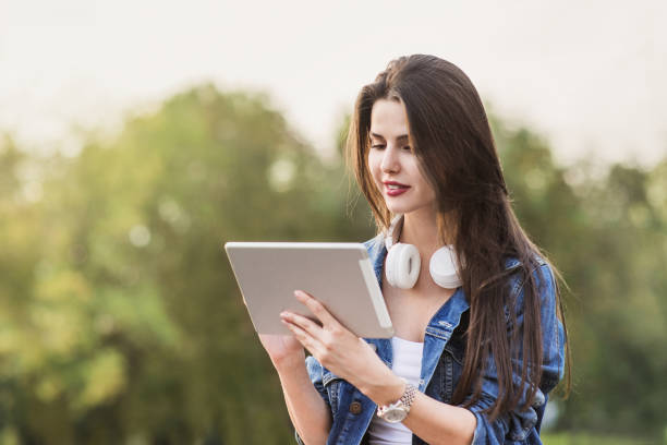 istock Beautiful girl using digital tablet computer in a city 1061679162