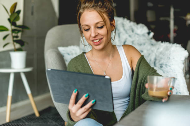istock Smiling woman looking at digital tablet 1061690344