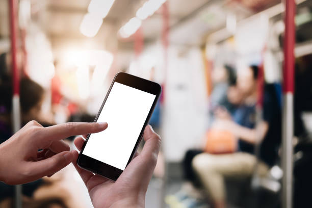 istock Close up Woman hand Using a Smart Phone with blank screen at subway station. 1061697136