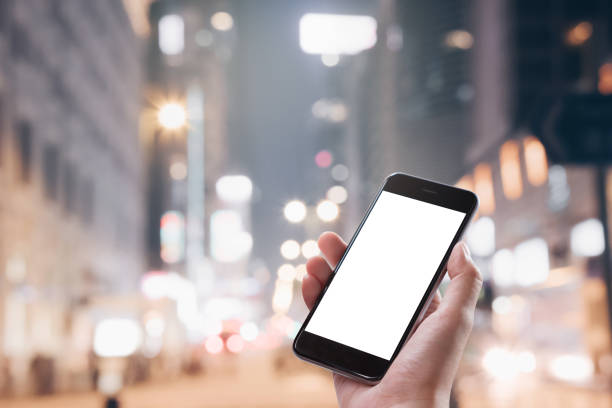 istock Close up Woman hand Using a Smart Phone with blank screen at night market. 1061697238