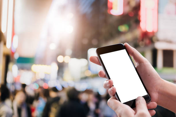 istock Close up Woman hand Using a Smart Phone with blank screen at shopping mall. 1061697454