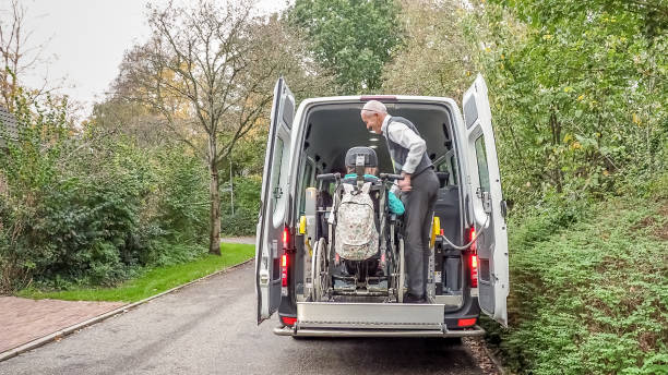 a senior retired man helping to transport disabled people - volunteer senior adult teenager occupation imagens e fotografias de stock