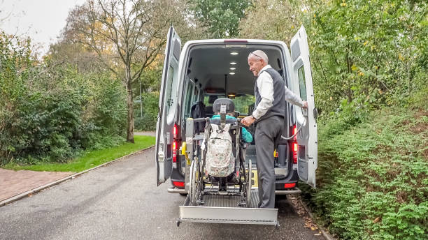 a senior retired man helping to transport disabled people - volunteer senior adult teenager occupation imagens e fotografias de stock