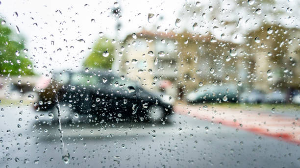 istock rainy weather, autumn time. drops on the vehicle's windows and blurry effect. 1061703448