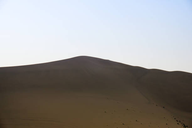 istock Desert sand dunes with blue sky background 1061709138
