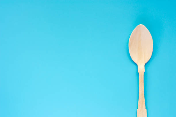 istock Wooden spoon on blue background with copy space for utensil and kitchenware concept 1061712954