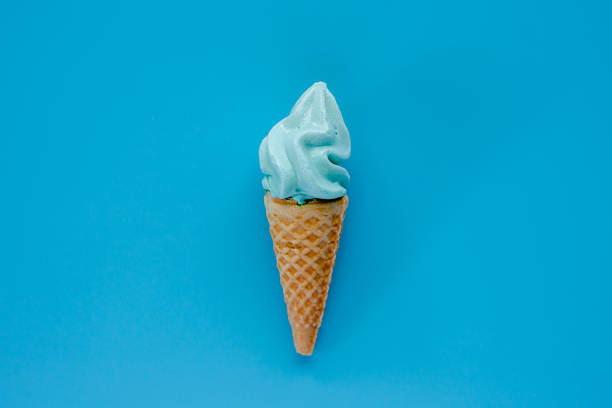 Ice cream cone on blue background for sweet and refreshing dessert concept