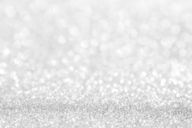 istock abstract background white Silver lights on christmas bokeh 1061713600