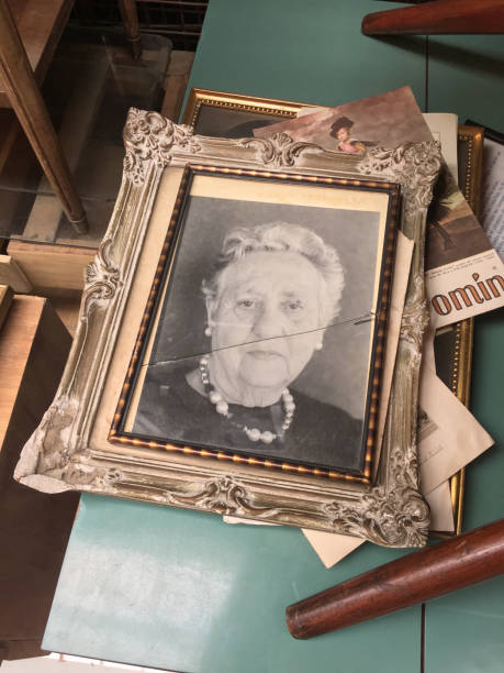 Buenos Aires, Argentina - October 21, 2018: Picture frame with broken flag with old woman portrait for sale at flea market in Palermo neighborhood. All kind of items can be found to be sold here