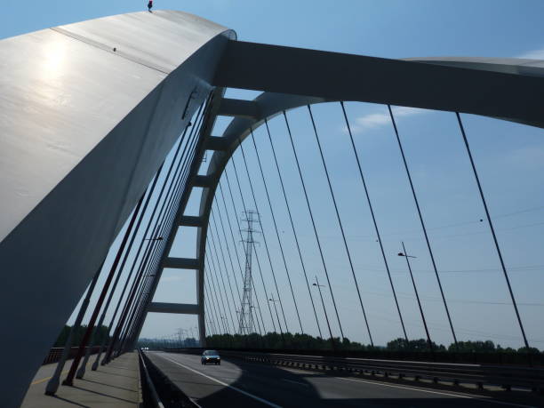 istock arching white steel suspension bridge 1061717254