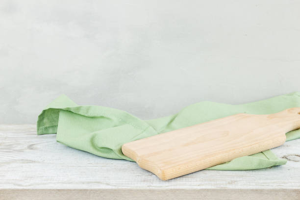 istock Napkin cloth and cutting board on gray wooden table 1061722094