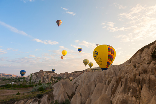 Traditional touristic attraction in Cappadocia.\nColorful hot air balloons flying over the beautiful valley at Cappadocia.\nApril 26, 2016 Nevşehir, TURKEY.