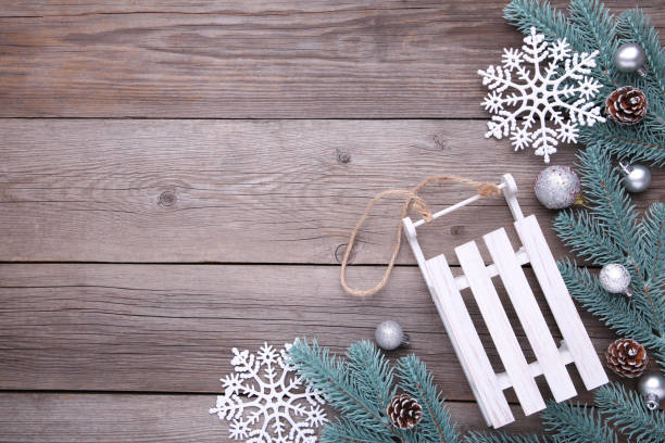 istock Christmas toy sledge with fir-tree branch on a grey background 1061725554