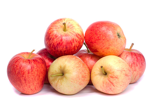 Close up view of a bunch of royal gala apples isolated on a white background.