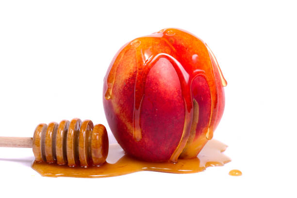 istock peach with honey dipper 1061732844