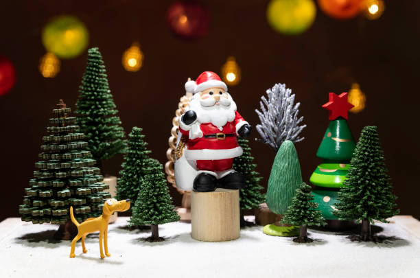 Santa Claus stand on circle wooden chair with dog watching among Christmas tree stock photo