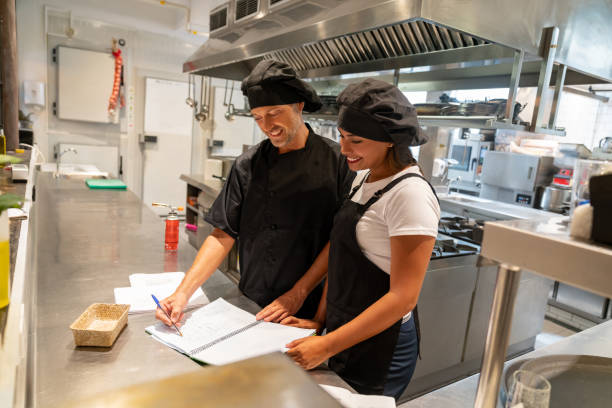 istock Chefs working at a restaurant preparing the menu together 1061735704