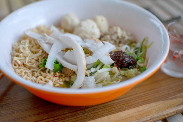 istock Noodles in an orange bowl placed on a table. 1061736194