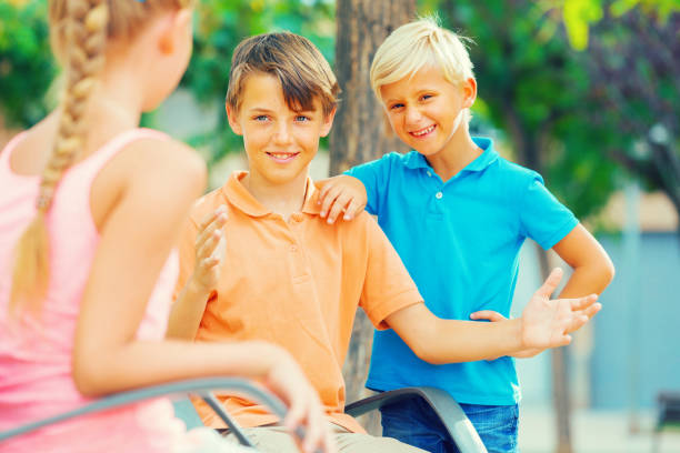 istock Two boys and girl are communicating on walk 1061736514