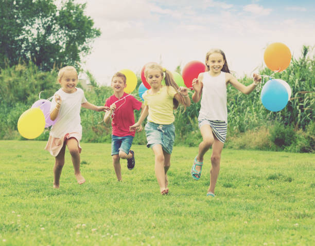 istock Children running and holding balloons 1061742238