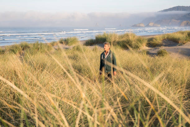 istock Man takes photo with digital tablet over sea 1061743960