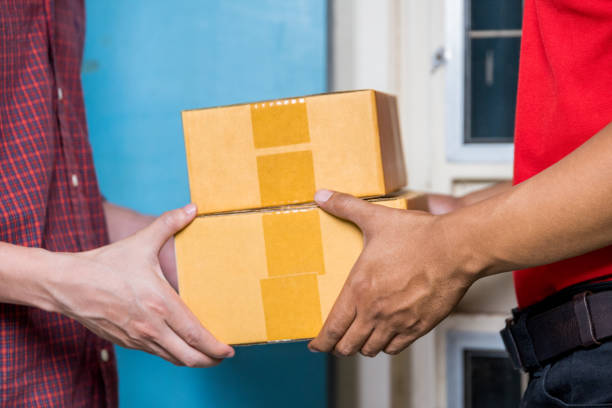 istock Male hand accepting a delivery of boxes from deliveryman. 1061745192