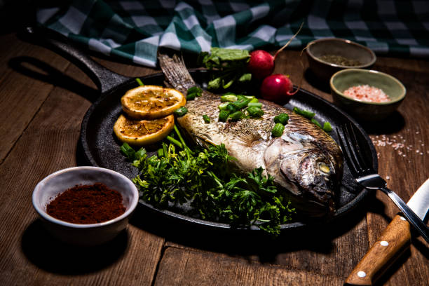 istock Gourmet Whole Dorado Fish on Metal Skillet Pan 1061745536