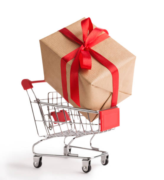 istock Cardboard gift box in shopping cart on white background 1061745744