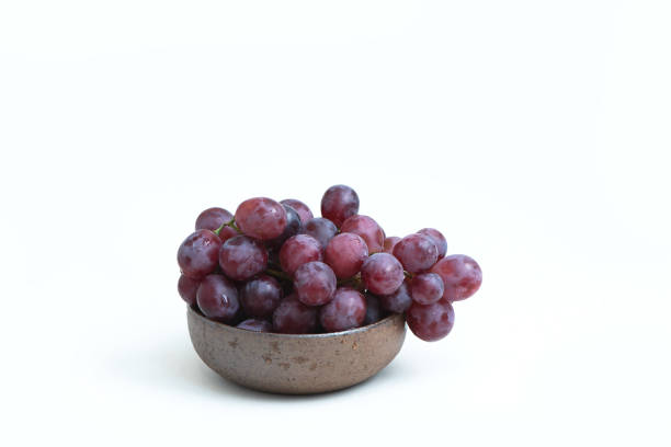 istock Red grapes on the ceramic bowl isolated on white 1061749420