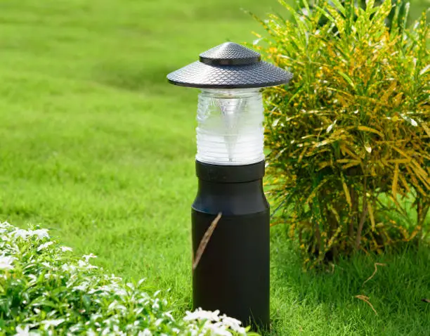 small lantern in a garden on the ground