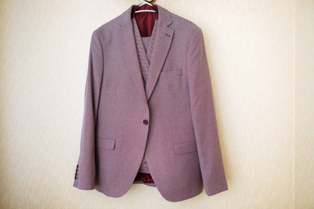 istock Strict men premium expensive suit hanging on hanger under the lamp 1061750216