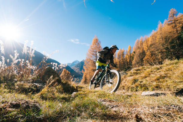 istock Mountain biker ascends slope at sunrise 1061750646