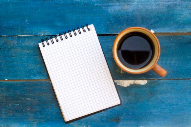 istock coffee cup and small paper in blue table 1061757658