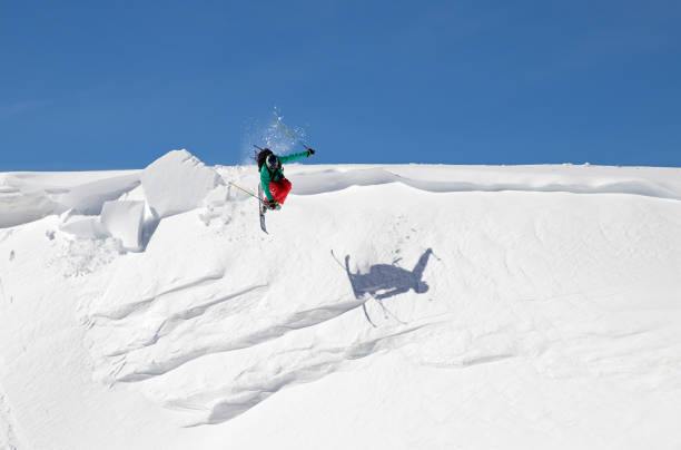 istock Young free skier jumping off a snow cornice with a trick 1061758350