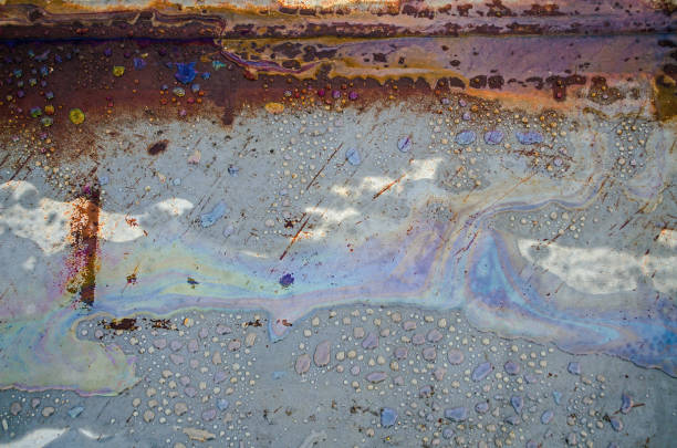 istock Rainbow chemical stains on the water in a puddle on road. 1061767770