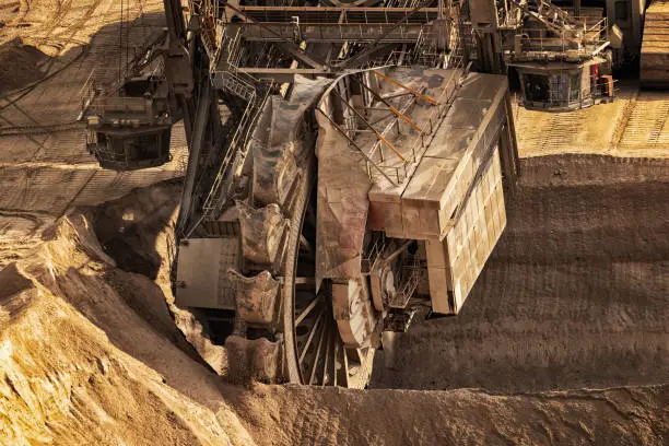 Huge bucket wheel excavator mining for brown coal in an open pit mine.