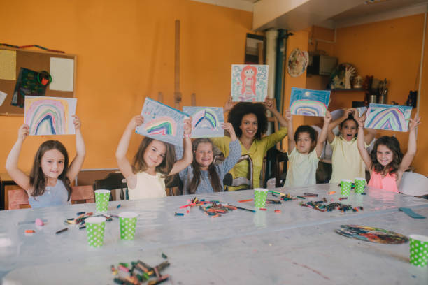istock children children holding up their drawings 1061769882